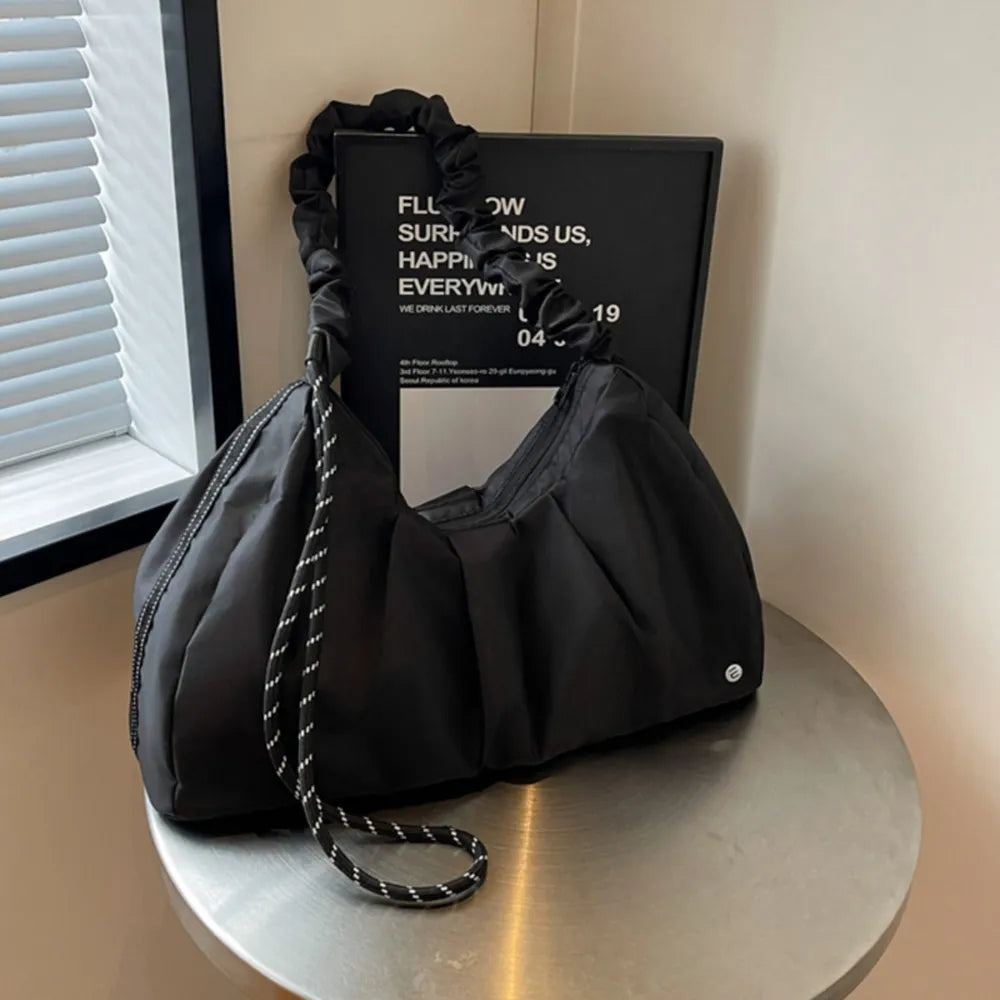 Black ruched handle crescent shoulder bag with rope strap detail