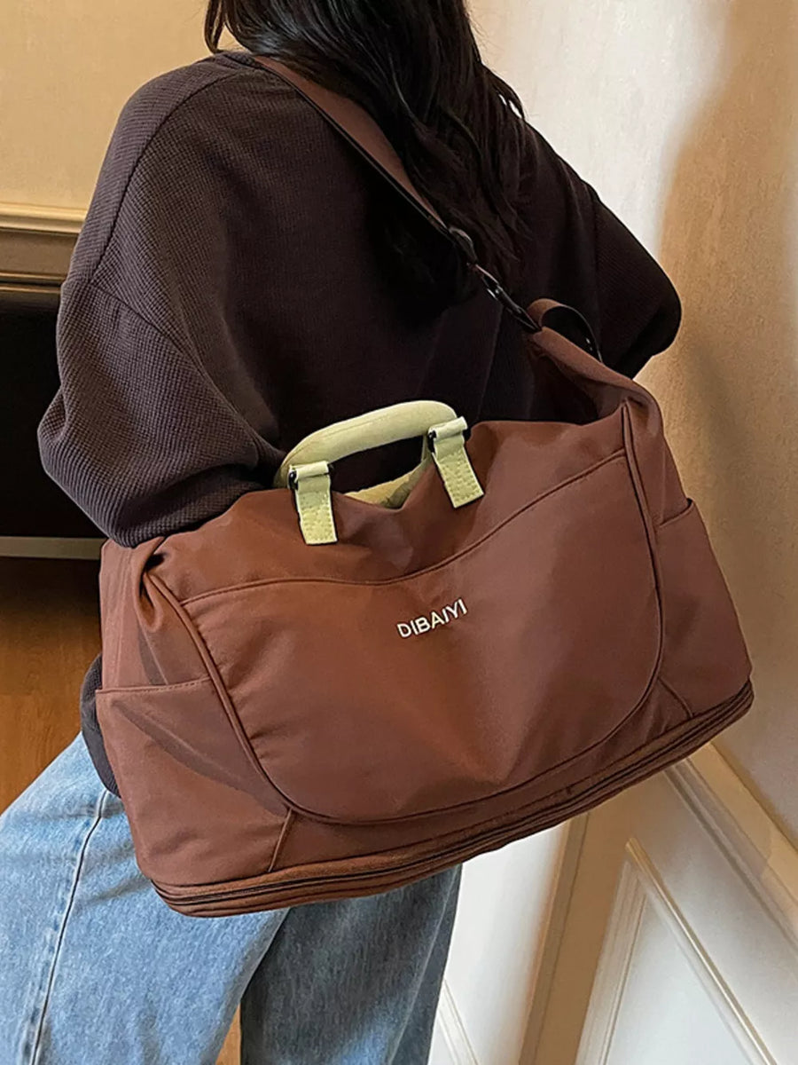Brown Oxford cloth travel duffel bag with light green handles and side pockets.