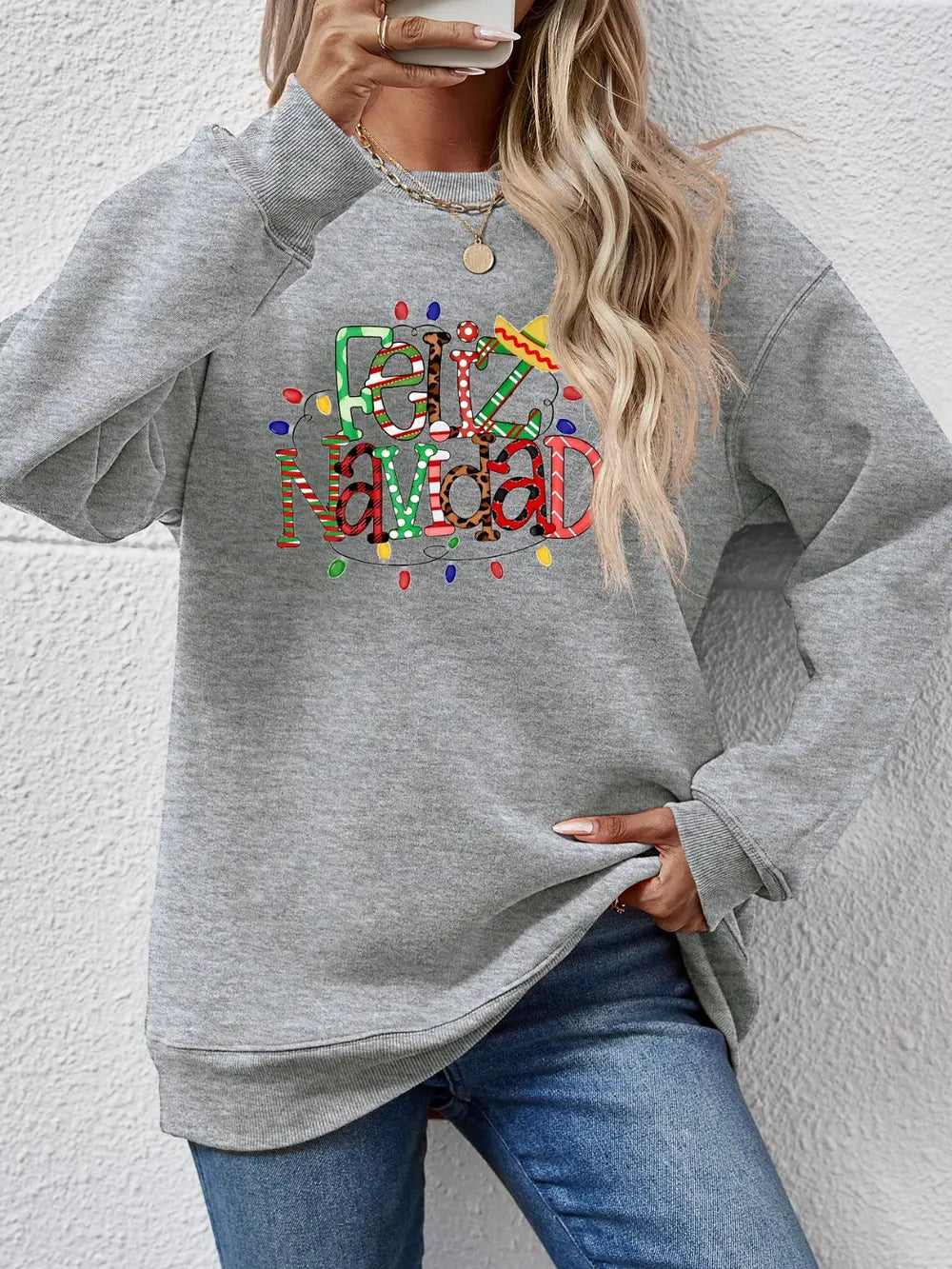 Gray graphic sweatshirt with Feliz Navidad text and Christmas lights, crew neck, long sleeves.