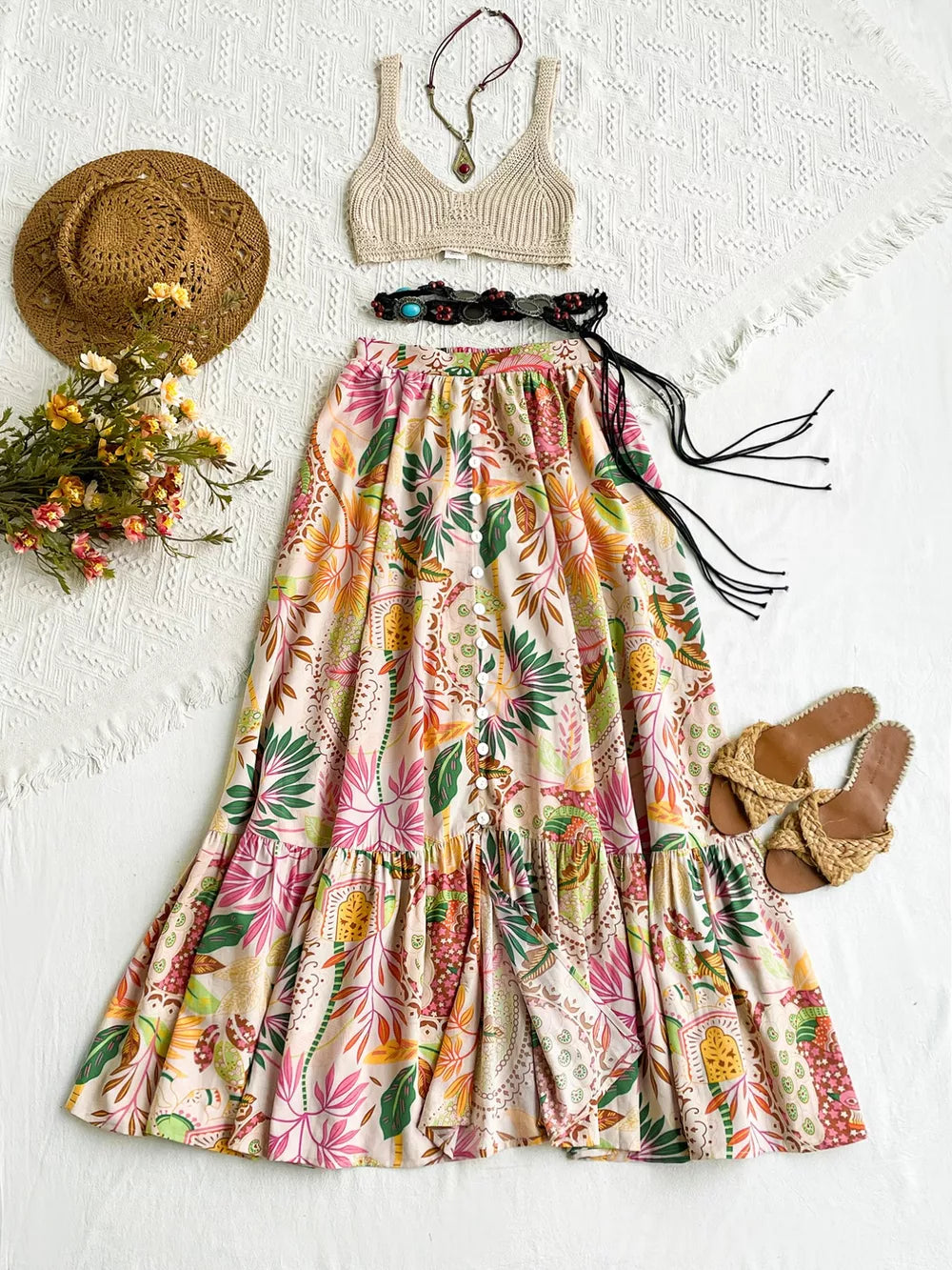 Tropical ruched maxi skirt with ruffles and decorative buttons, featuring a vibrant floral print.