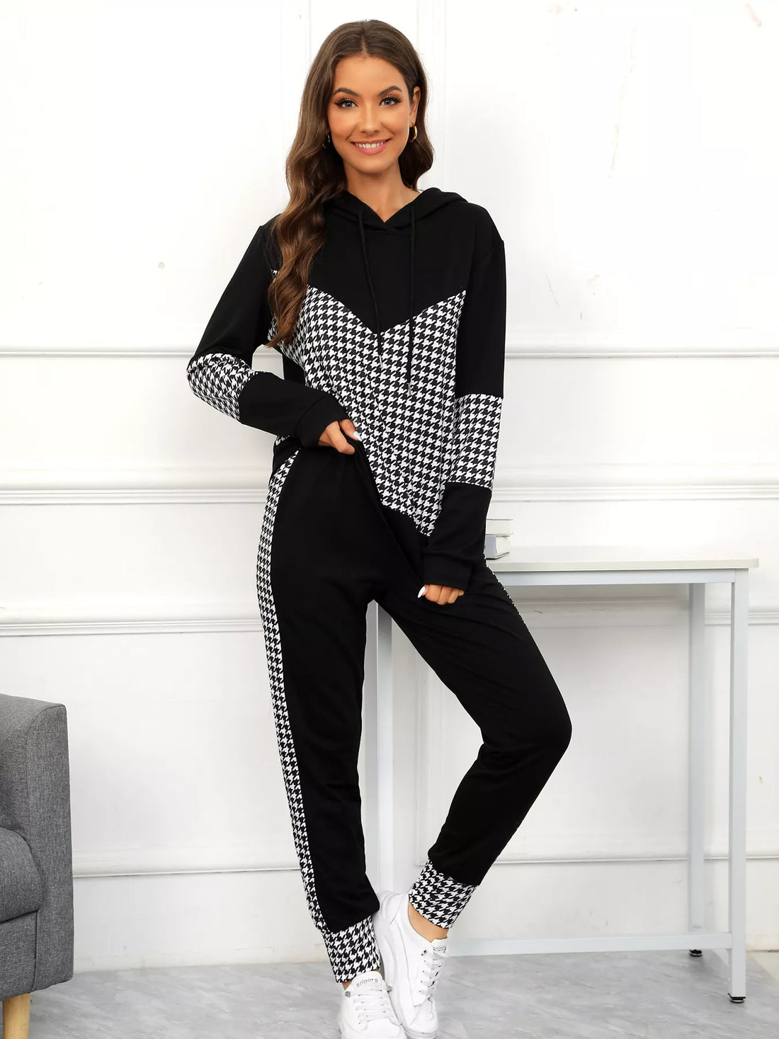 Black houndstooth hoodie and pants set with drawstring and chevron detail.