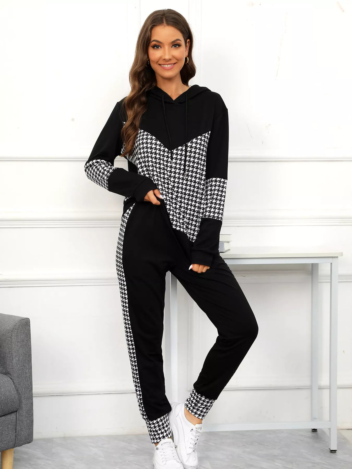 Black houndstooth hoodie and pants set with drawstring and chevron detail.
