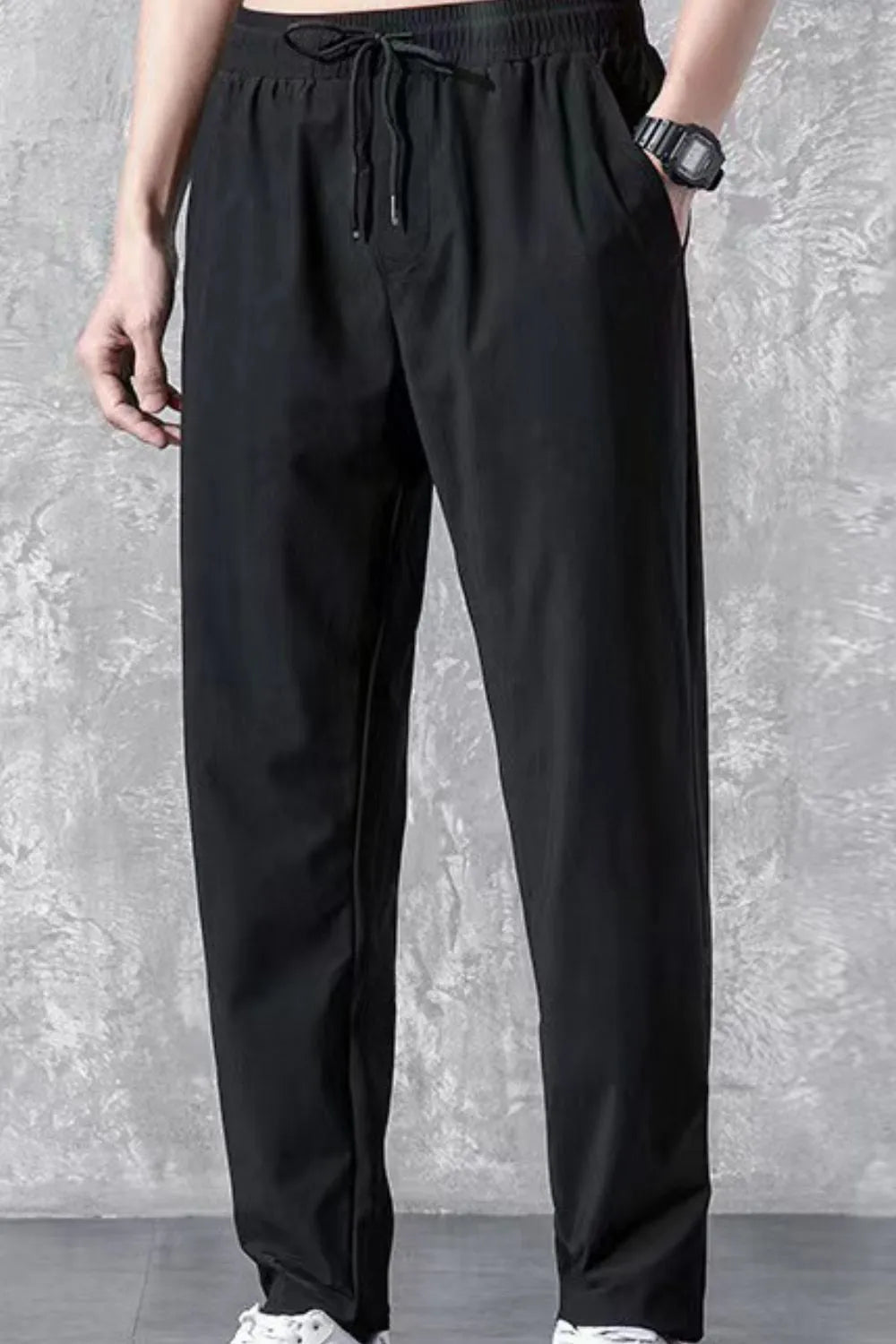 Black relaxed-fit acetate trousers with drawstring waist and pockets.