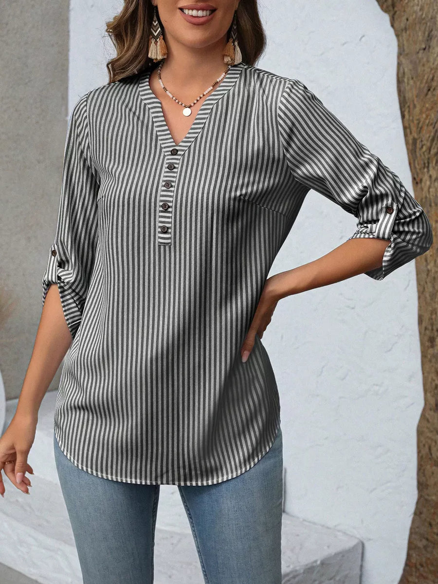 Vertical stripe V-neck blouse with roll-up sleeves and button detail.
