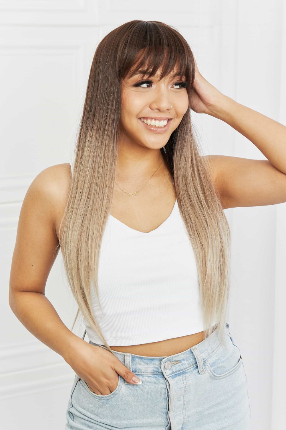 Ombre fringe synthetic hair extension in black to gray with straight, long hair.