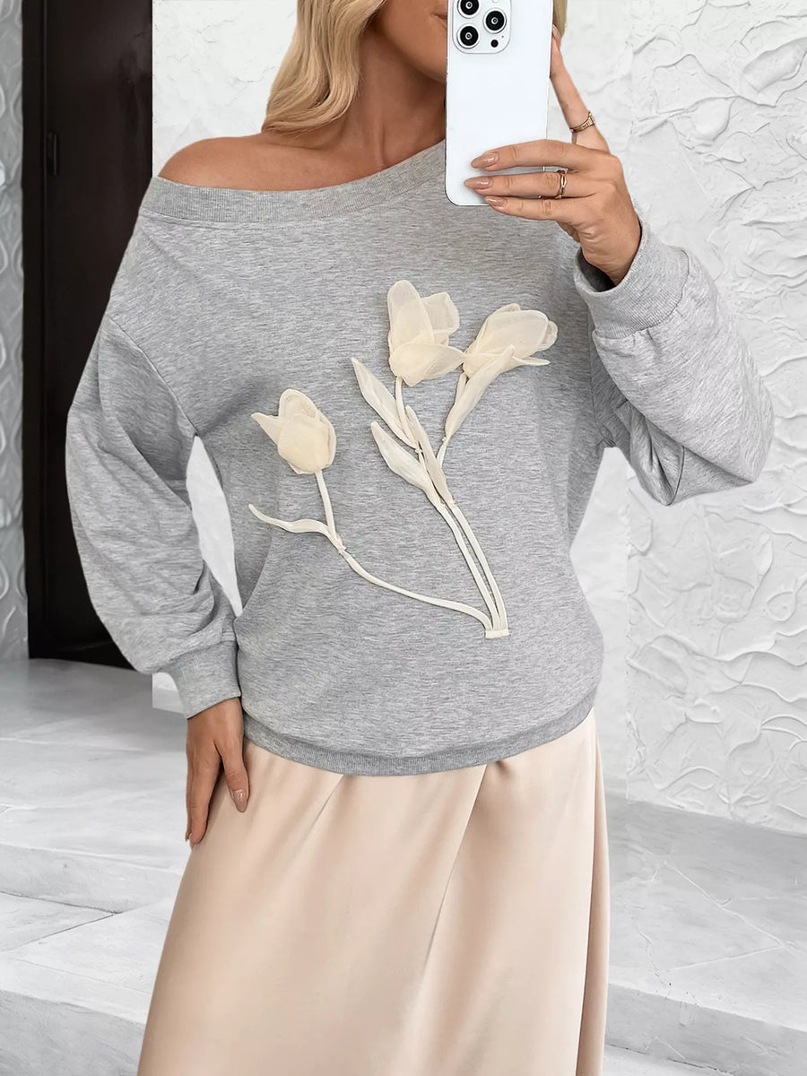 Gray boat neck sweater with floral applique detail