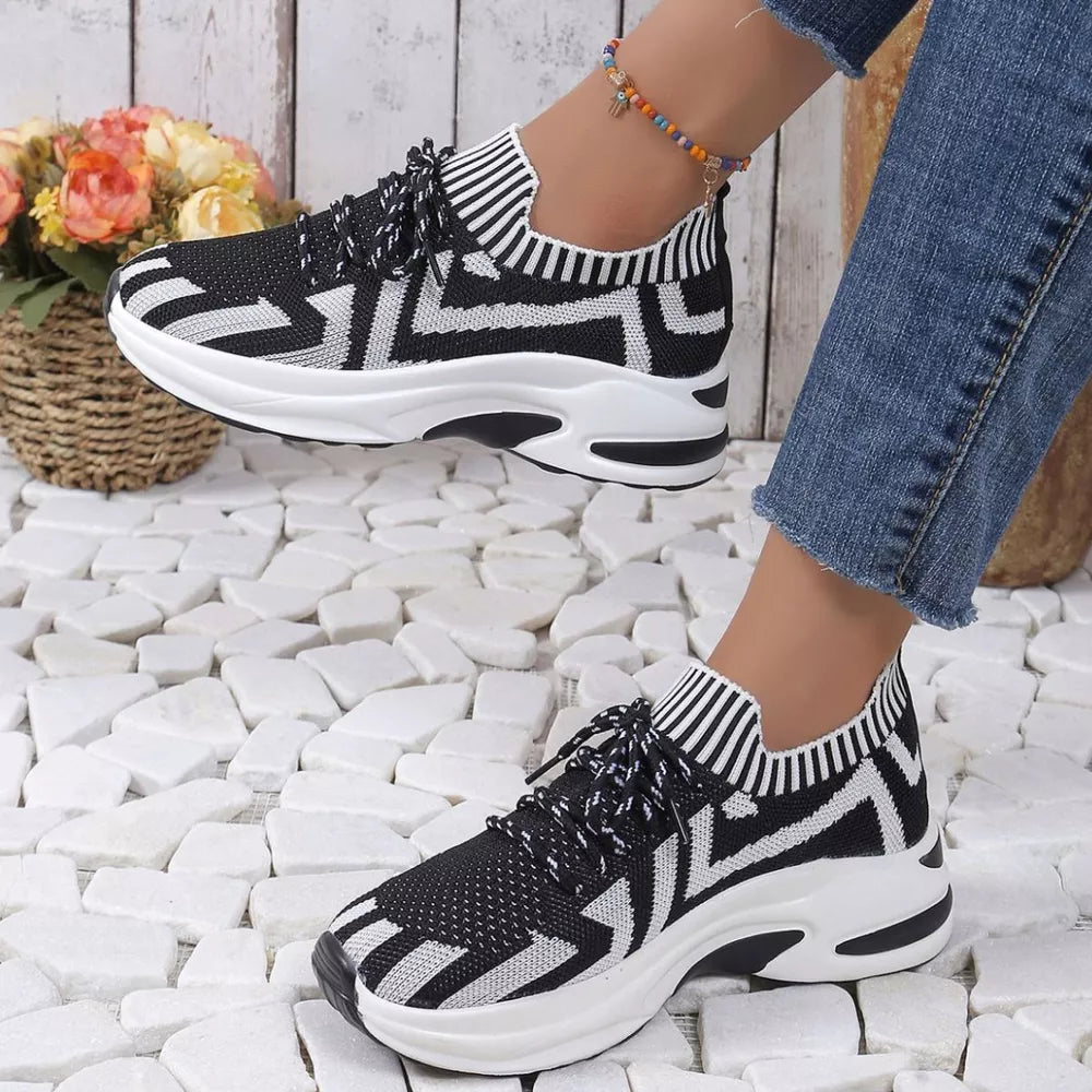 Black and white geometric knit platform sneakers with striped ankle cuff and white laces.