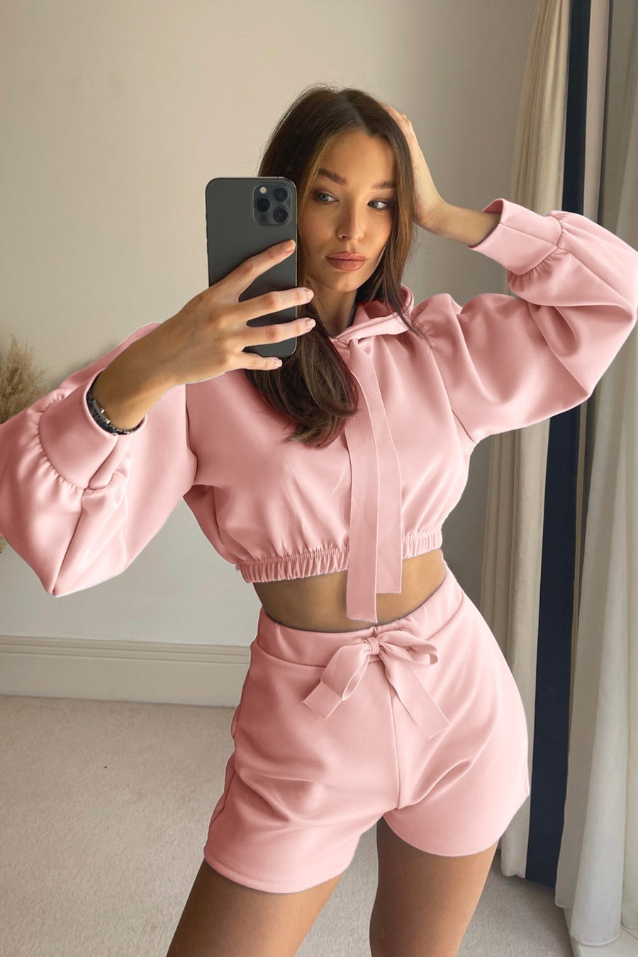 Blush pink cropped hoodie with tie detail and matching shorts with bow.