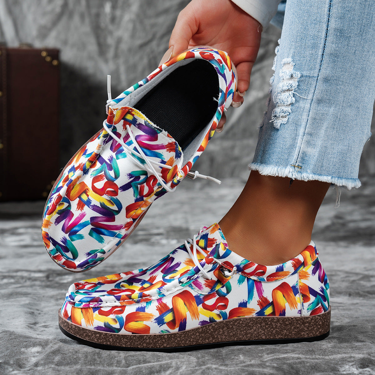 Printed casual slip-on loafers with abstract brushstroke pattern in white and multicolor.