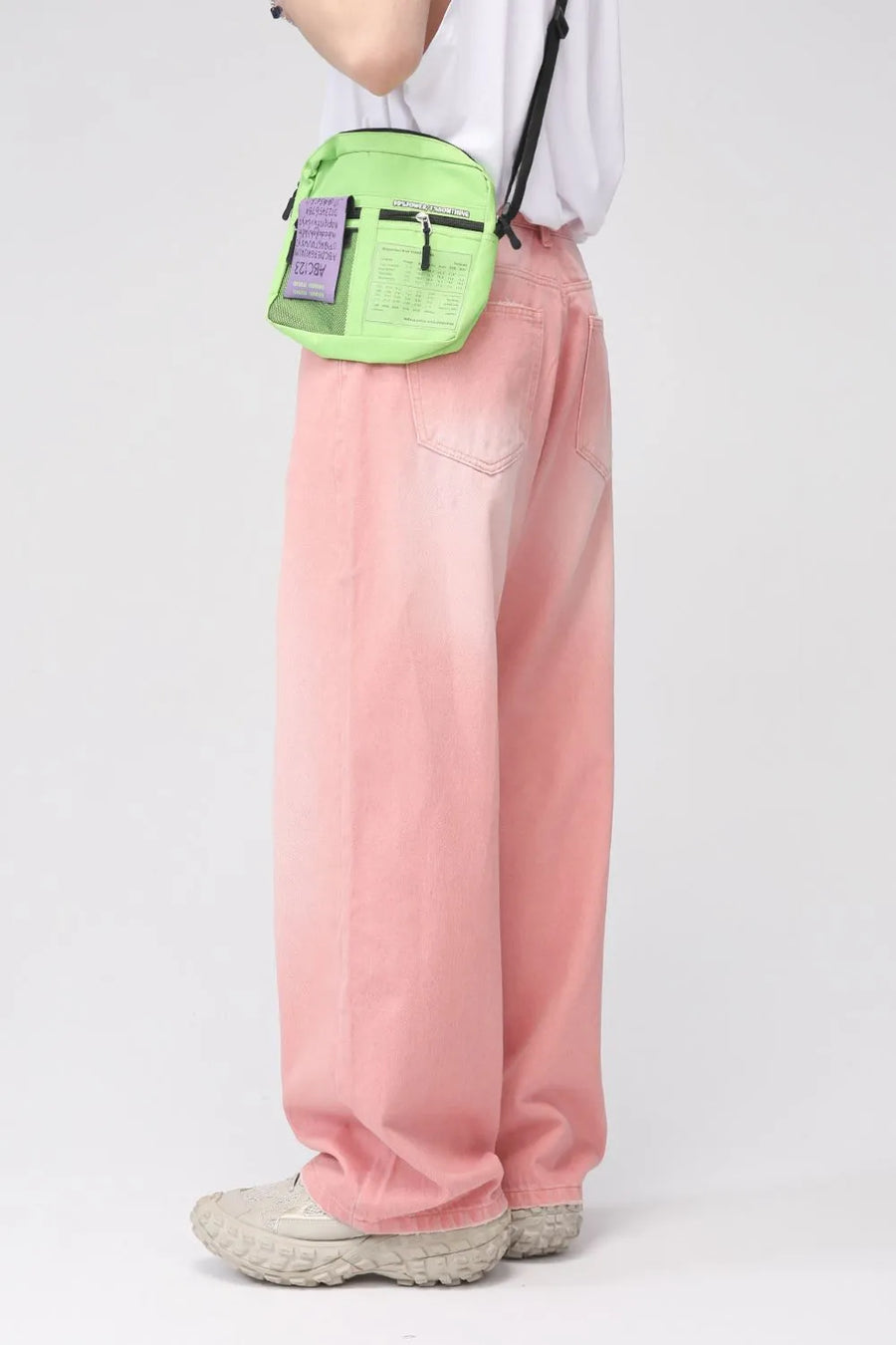 Faded pink wide-leg denim trousers with a relaxed fit, shown on a model.