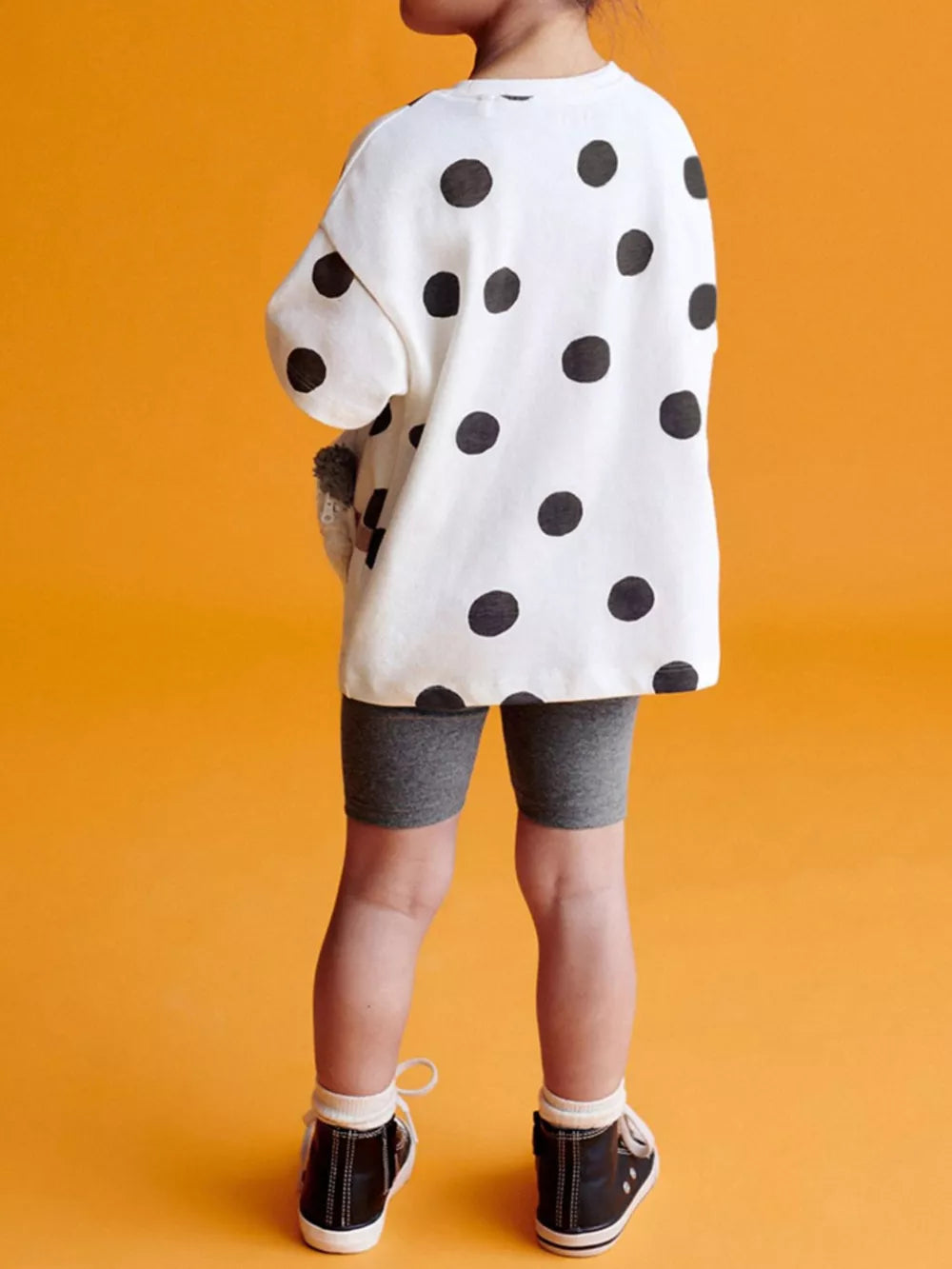 White polka dot sweatshirt with grey biker shorts for toddlers.