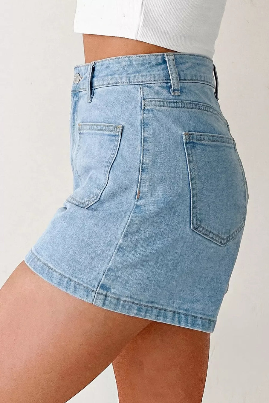 Light wash denim shorts with high rise and patch pockets.