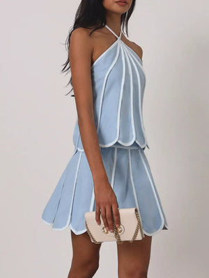 Light blue halter top and pleated mini skirt set with white trim and scalloped hem.