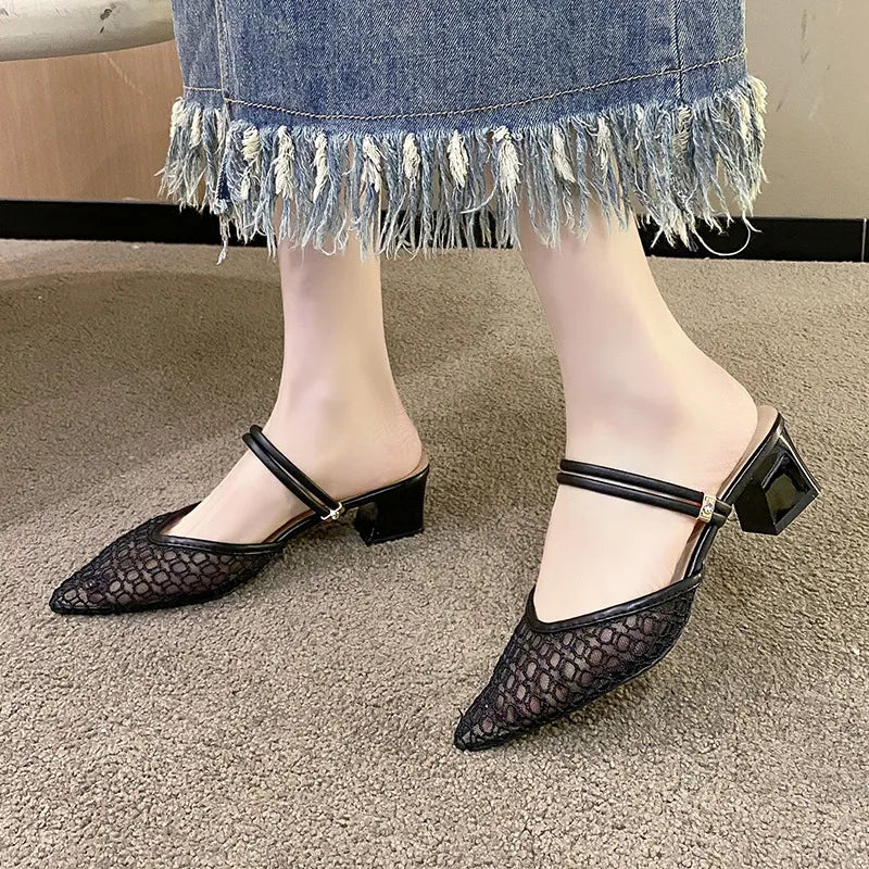 Black lace slingback pointed-toe mules with double strap detail and block heel.