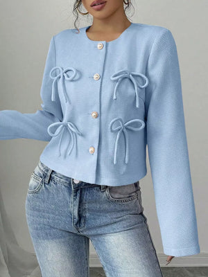 Light blue textured jacket with bow details and gold buttons