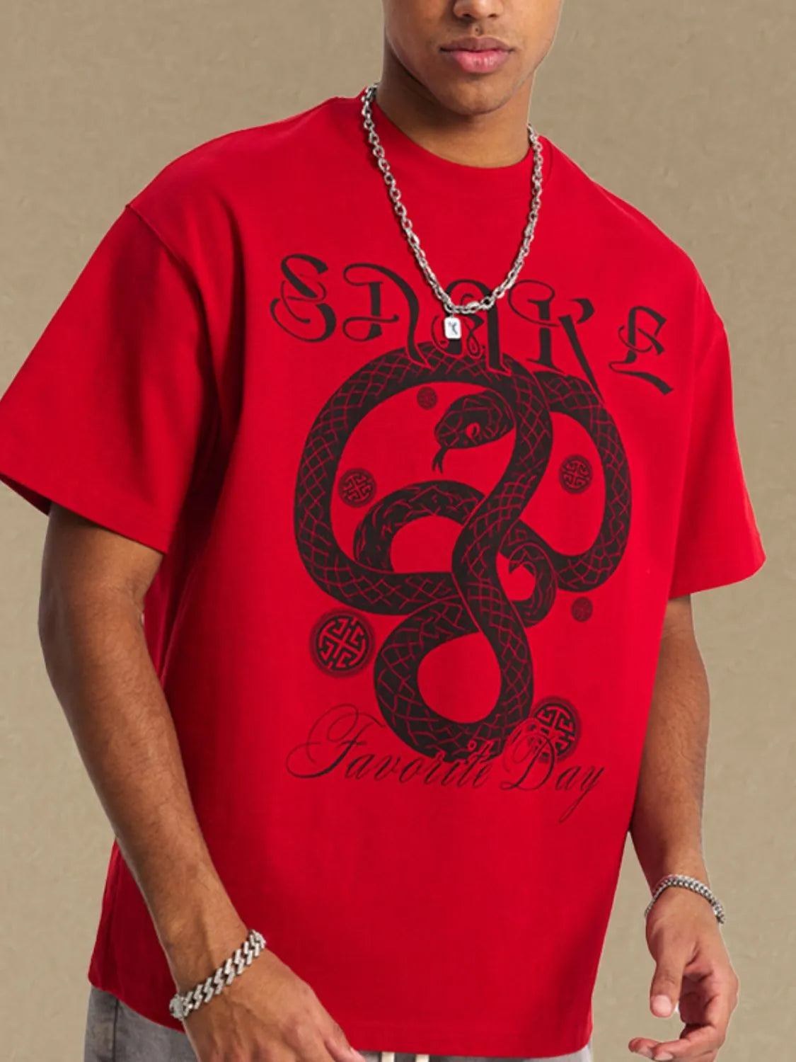 Red oversized tee with black serpent graphic and text.