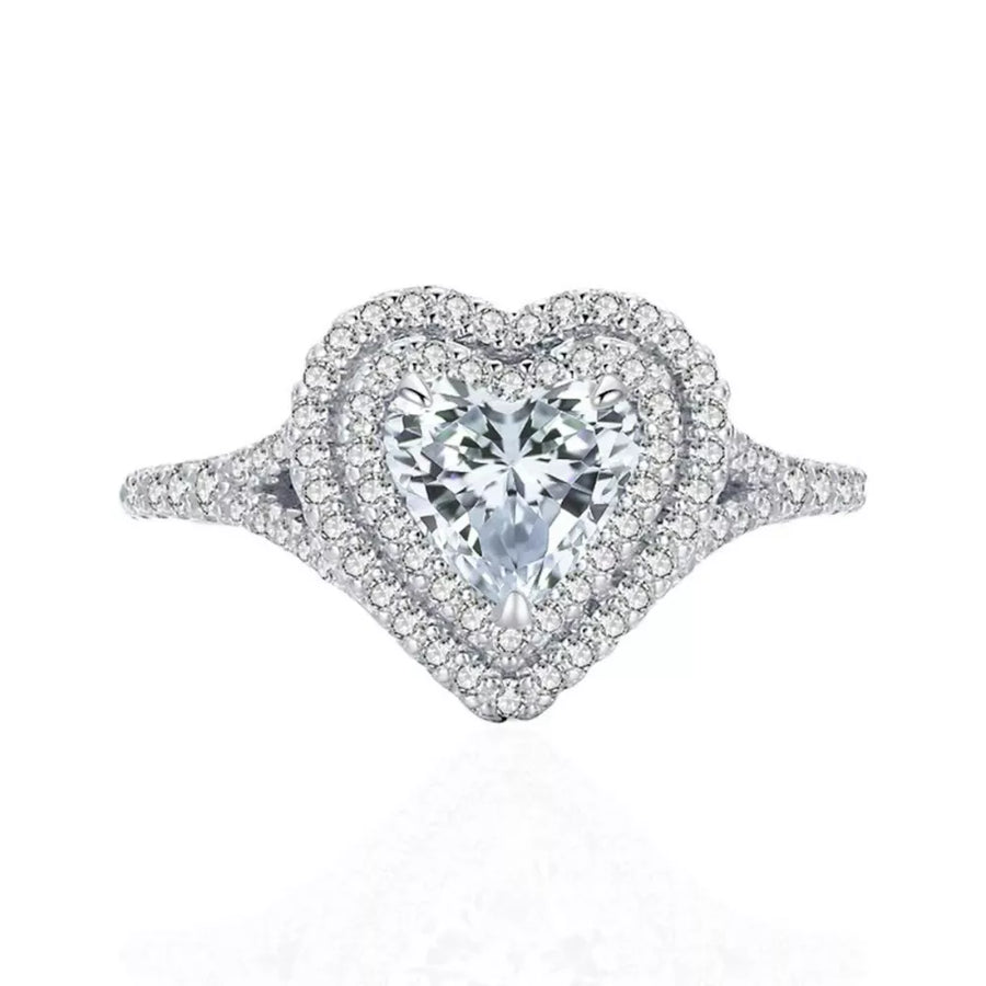 Silver ring with a heart-shaped moissanite center stone and a double diamond halo.
