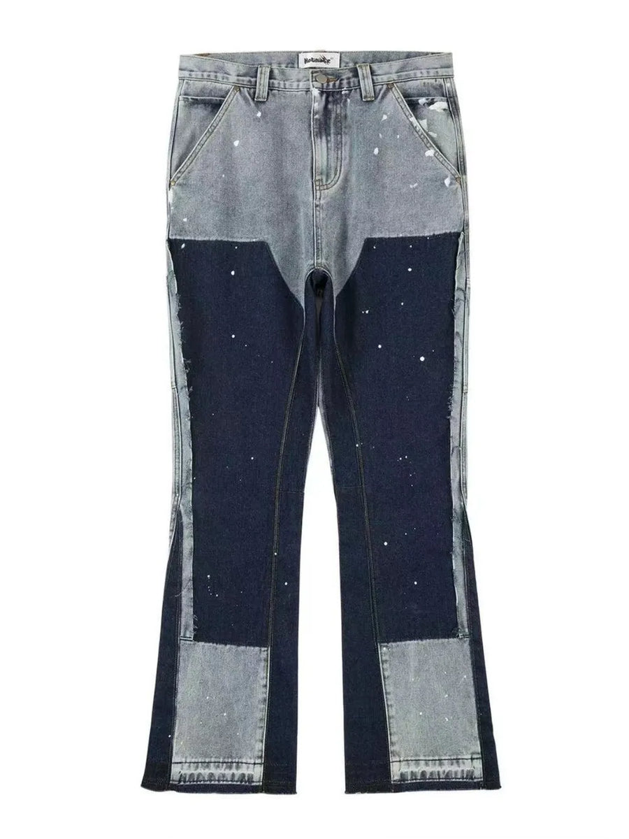 Split panel bootcut jeans in dark blue and light blue denim with paint splatter detail.