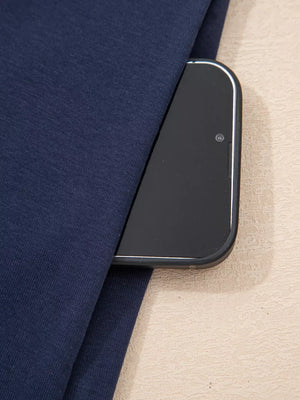 Dark navy mini dress with a pocket holding a smartphone.