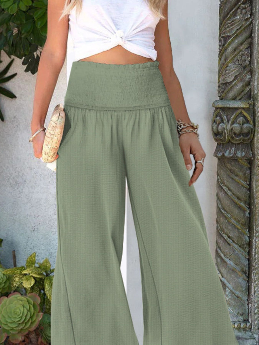 Light Green smocked waist wide-leg trousers with textured fabric.