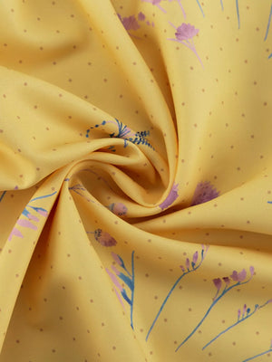 Yellow fabric with a delicate floral print and a subtle dot pattern.