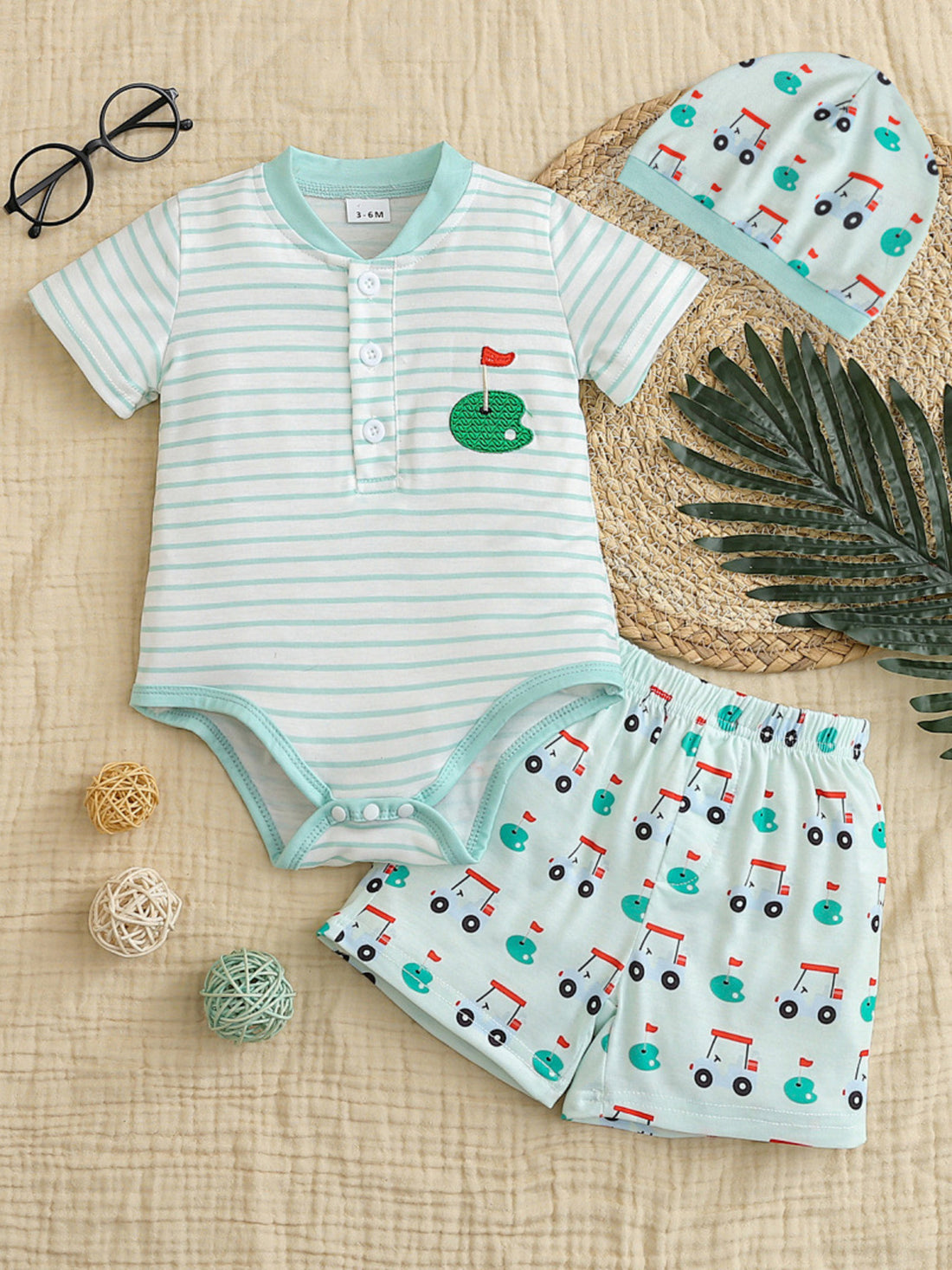 Baby golf bodysuit and shorts set with golf cart print and matching hat.