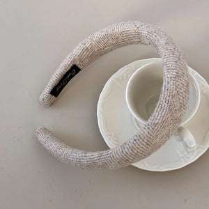 Textured tweed padded headband in Khaki with a herringbone pattern.