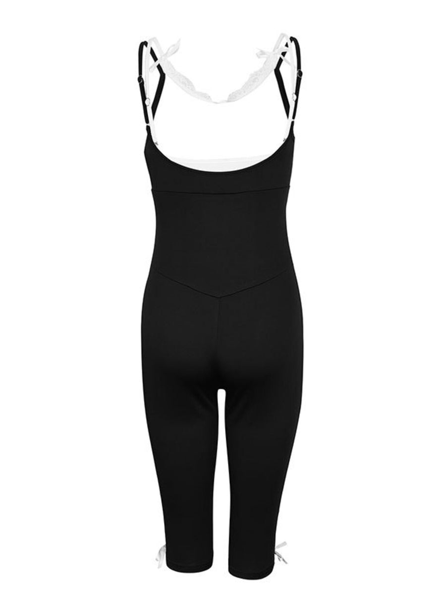 Black capri romper with lace trim and tie details at the leg openings.