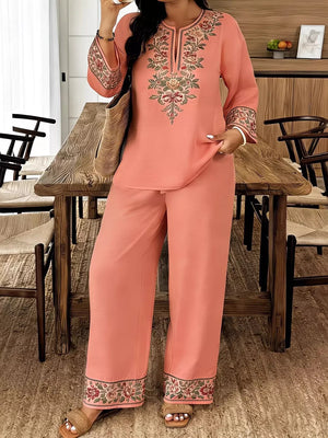 Coral embroidered tunic and wide-leg pants set with split neckline and bell sleeves.