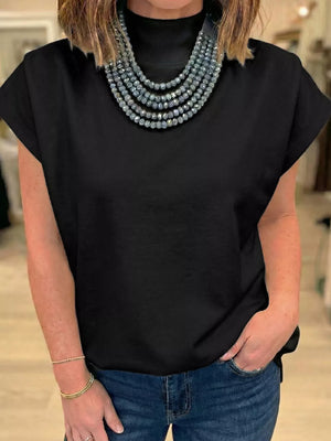Black mock neck cap sleeve maternity t-shirt styled with a beaded necklace and jeans.