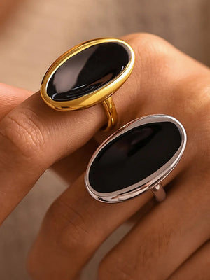 Sculpted oval onyx cocktail rings in gold and silver settings.