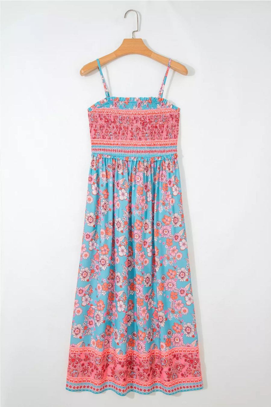 Bohemian floral maxi dress with smocked pink bodice and blue floral print skirt.