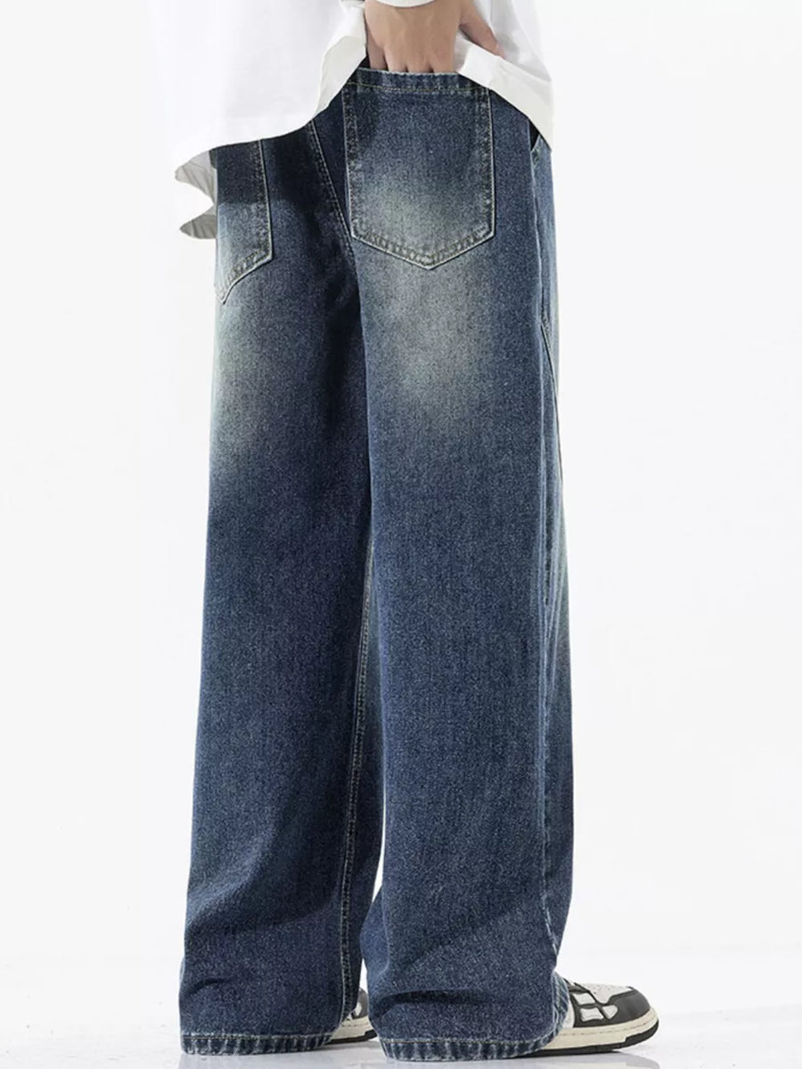 Relaxed fit wide-leg jeans in dark wash denim with a drawstring waist and distressed details.