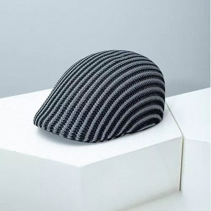 Textured striped flat cap in black and white with a breathable knit design.