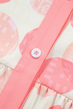 Polka dot babydoll shirt with pink ruffle trim and button detail.