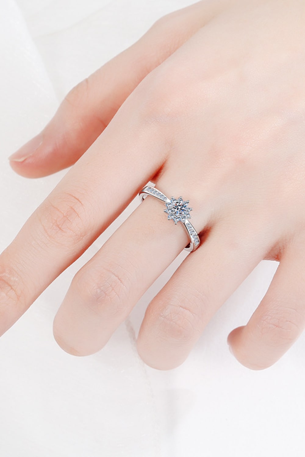 Silver moissanite ring with a celestial cluster center and pave band.