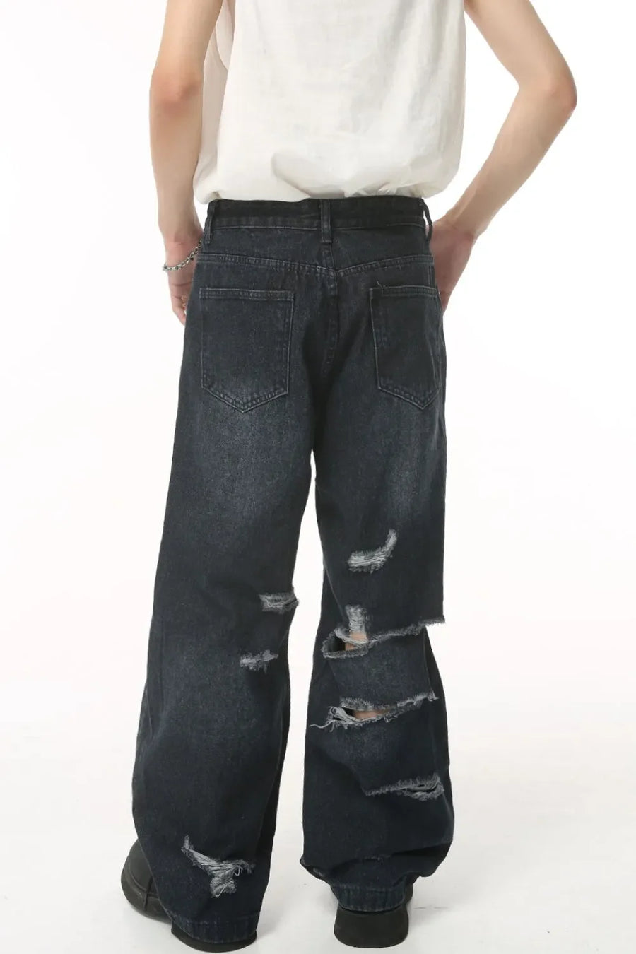 Distressed baggy jeans in dark denim with statement rips and a relaxed fit.