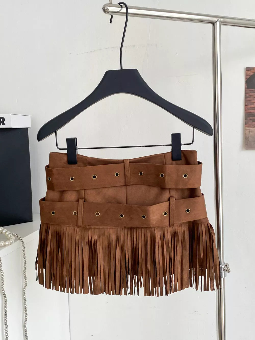 Brown suede belted mini skirt with fringe and antique brass grommets.