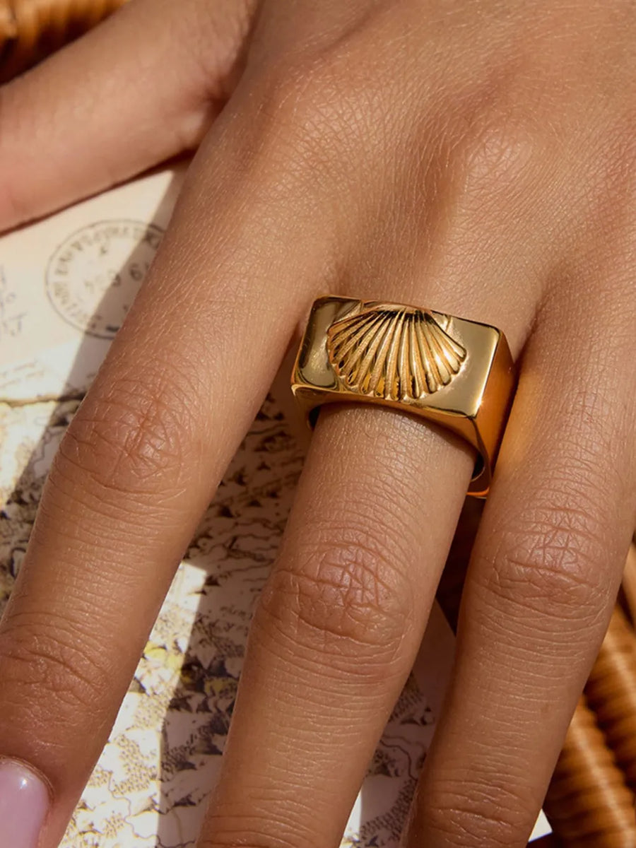 Gold ring featuring intricate shell pattern engraving and shell pattern