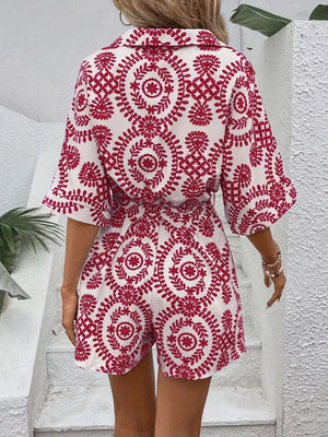 Deep Red printed tie-waist romper with buttoned collar and short sleeves.