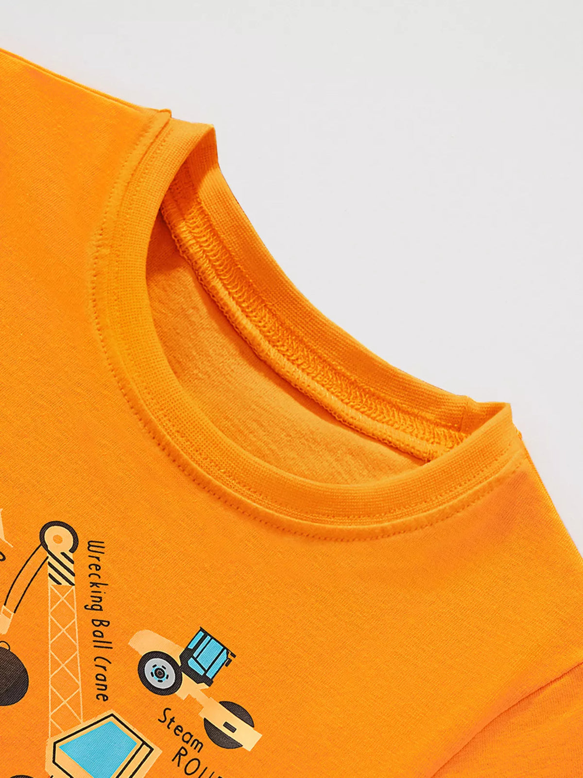 Kids' orange cotton t-shirt with construction vehicle graphic and text.
