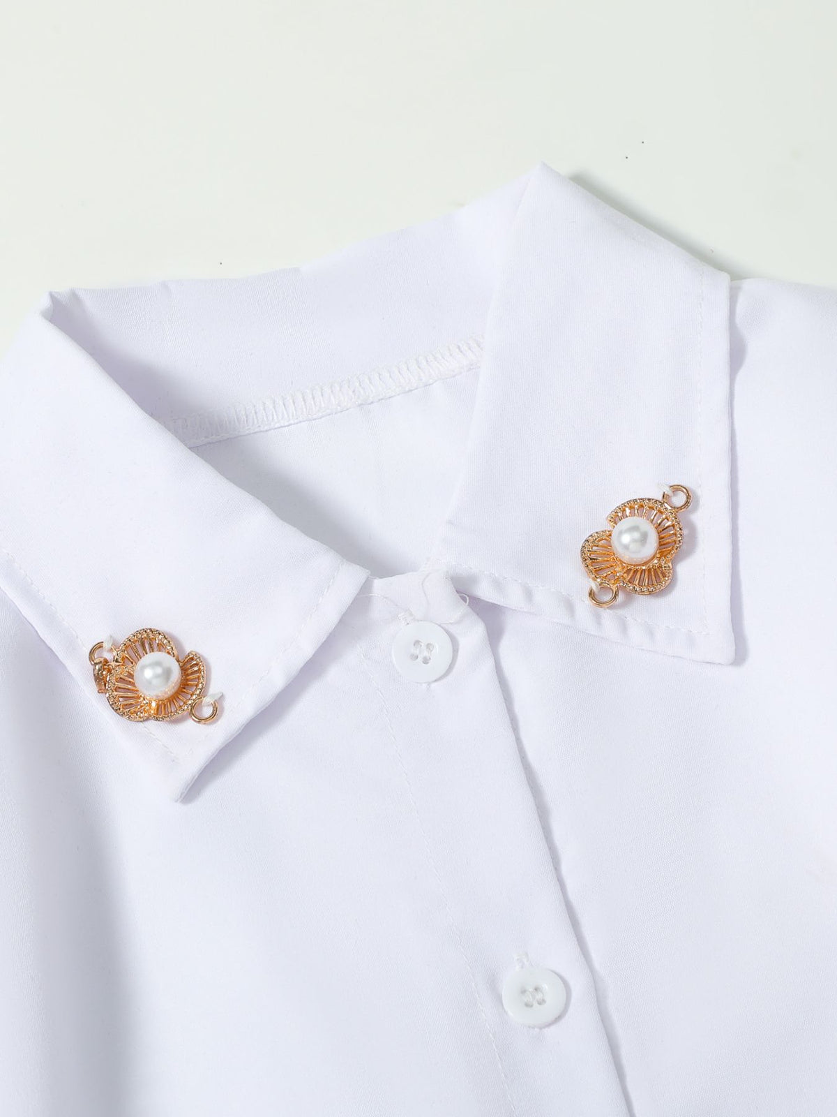 White button-down shirt dress with pearl and gold flower collar clips
