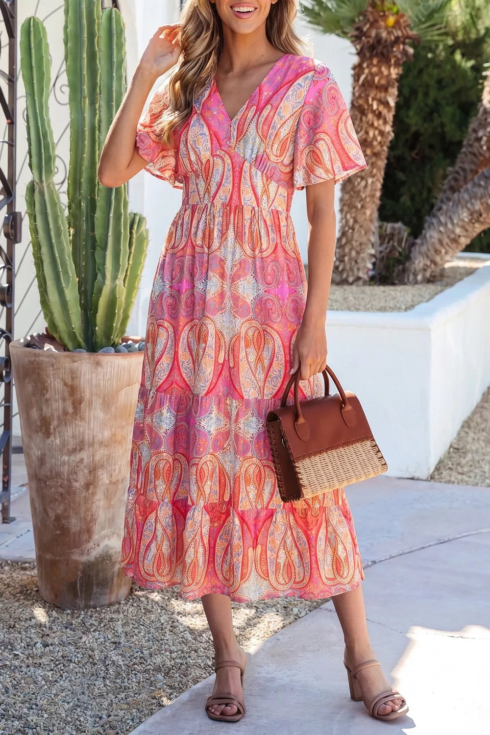 Paisley print v-neck short sleeve boho midi dress in coral pink with tiered skirt.