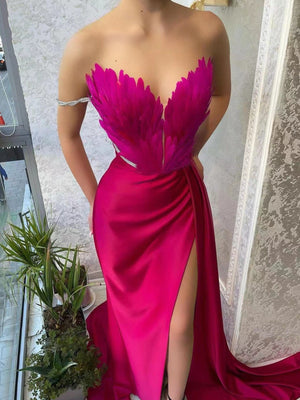 Rose red feather embellished maxi dress with a high slit and draped skirt.