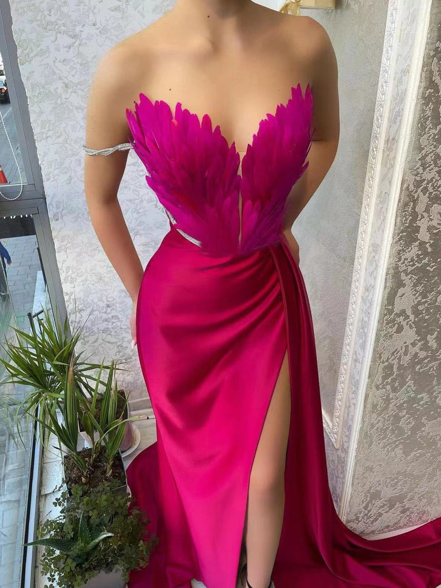Rose red feather embellished maxi dress with a high slit and draped skirt.