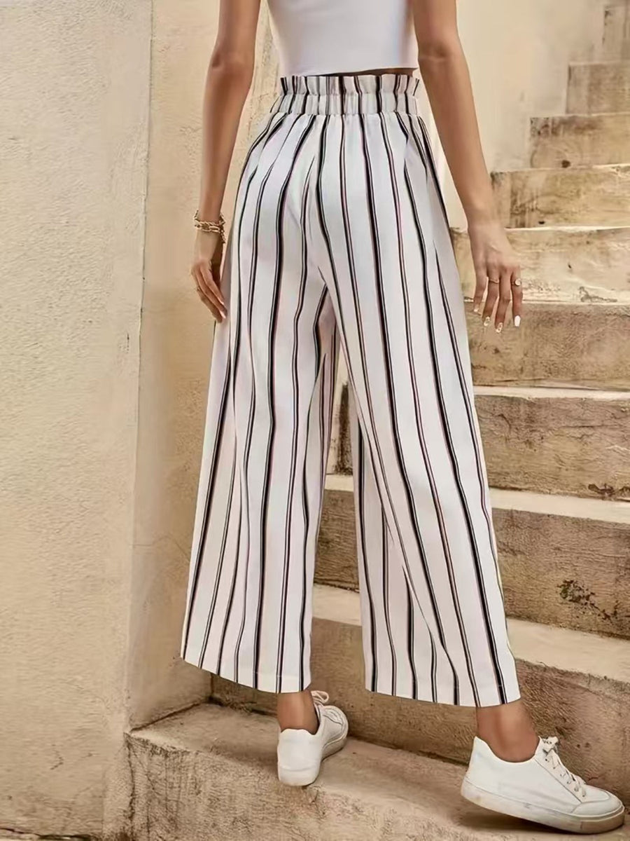 High-waisted palazzo pants with black and white vertical stripes and a cinched waist.