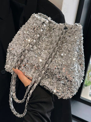 Dazzling sequin bucket shoulder bag in silver with a silver chain strap.