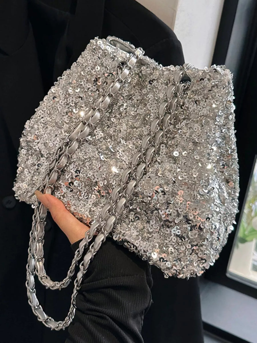 Dazzling sequin bucket shoulder bag in silver with a silver chain strap.