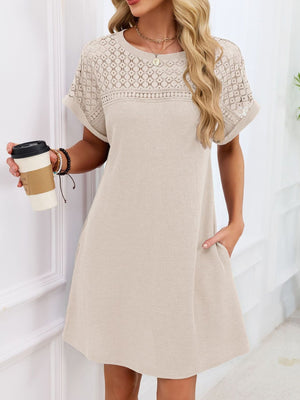 Beige t-shirt dress with short sleeves and sheer lace yoke detail.