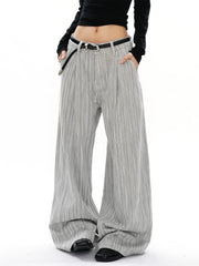Men's grey striped wide-leg sweatpants with a black belt and pleats.